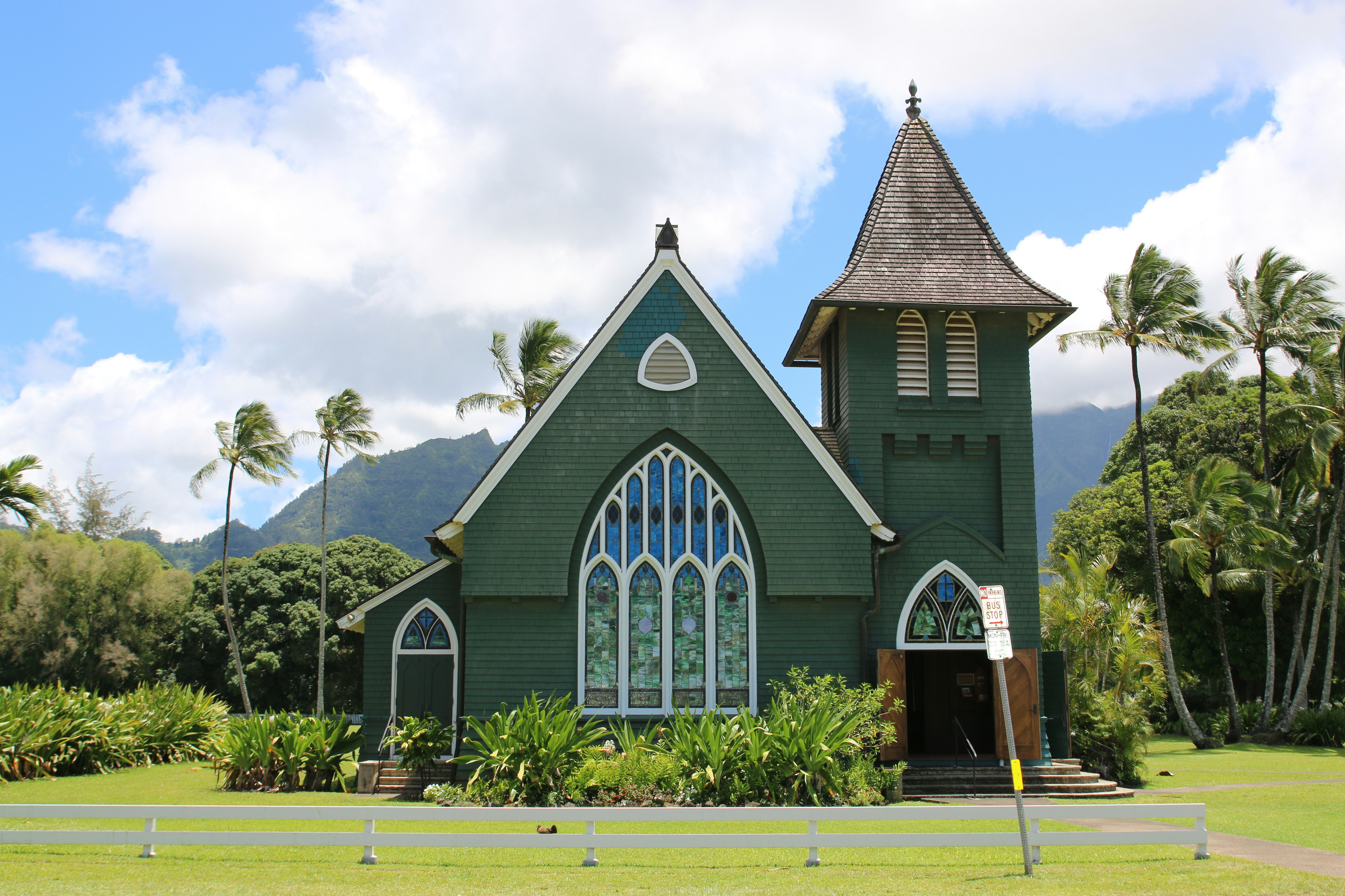 brown and black concrete building under white clouds during daytime