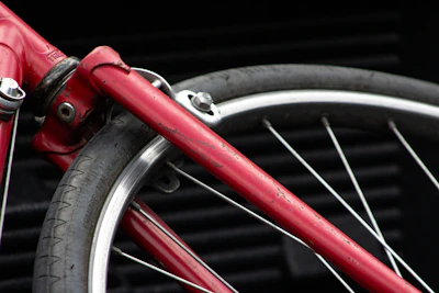 Close-up of a worn bicycle wheel covered in dust from the journey