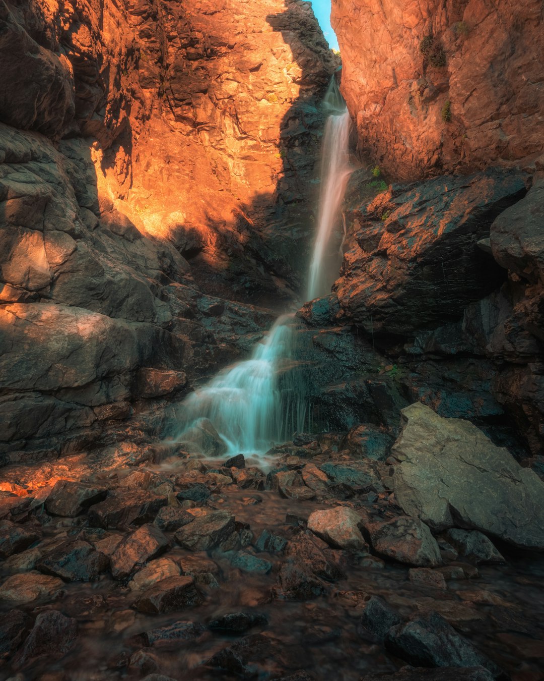 brown rocky mountain with waterfalls