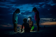 kids with flashlight playing outdoors.