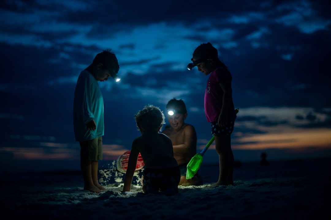 Kids building sand castles at the beach at night with torches - Photo by Ben McLeod | best digital marketing - London, Bristol and Bath marketing agency