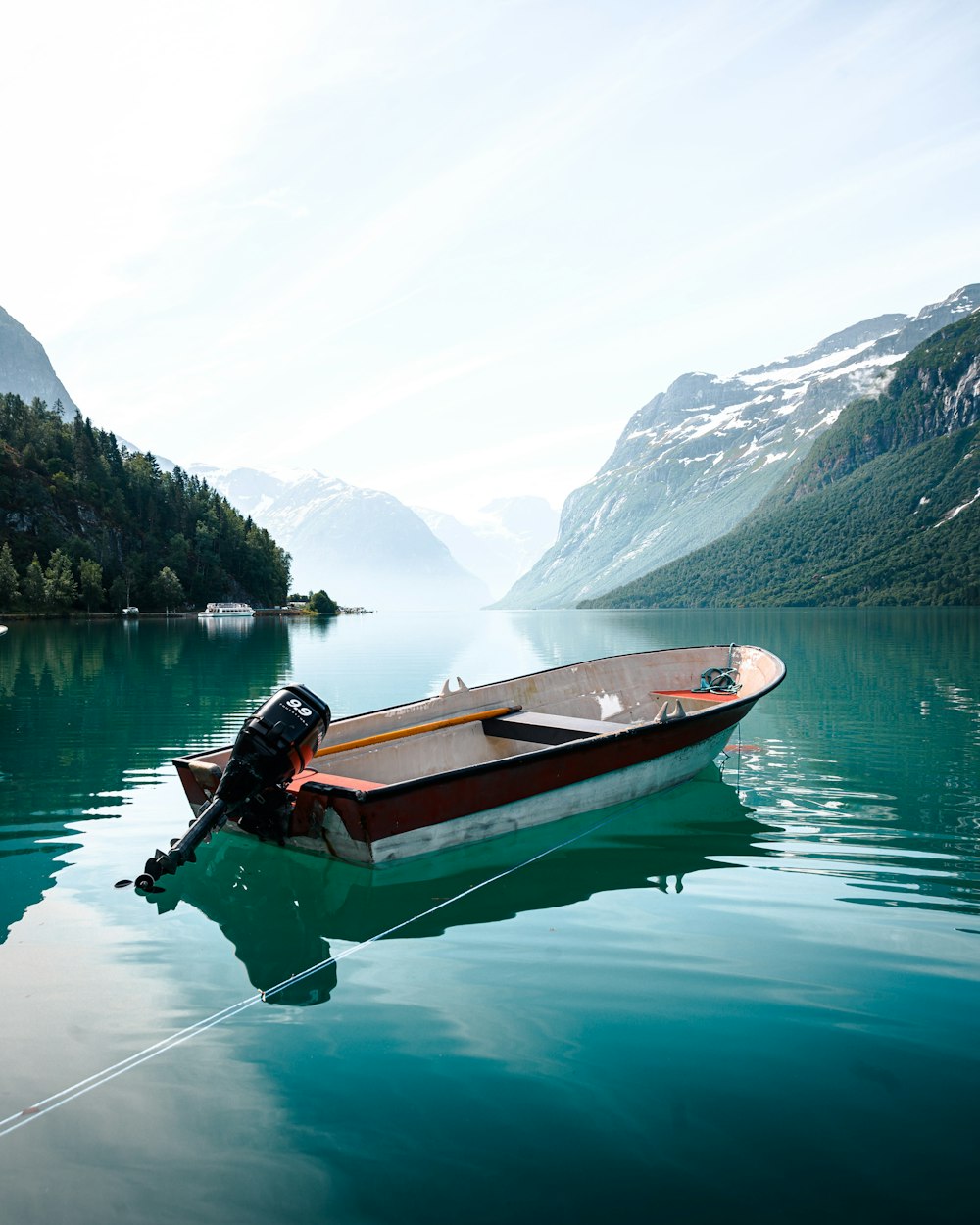 brown and white boat on lake during daytime