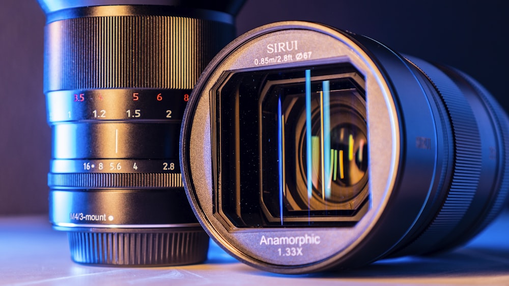 black nikon camera lens on blue textile