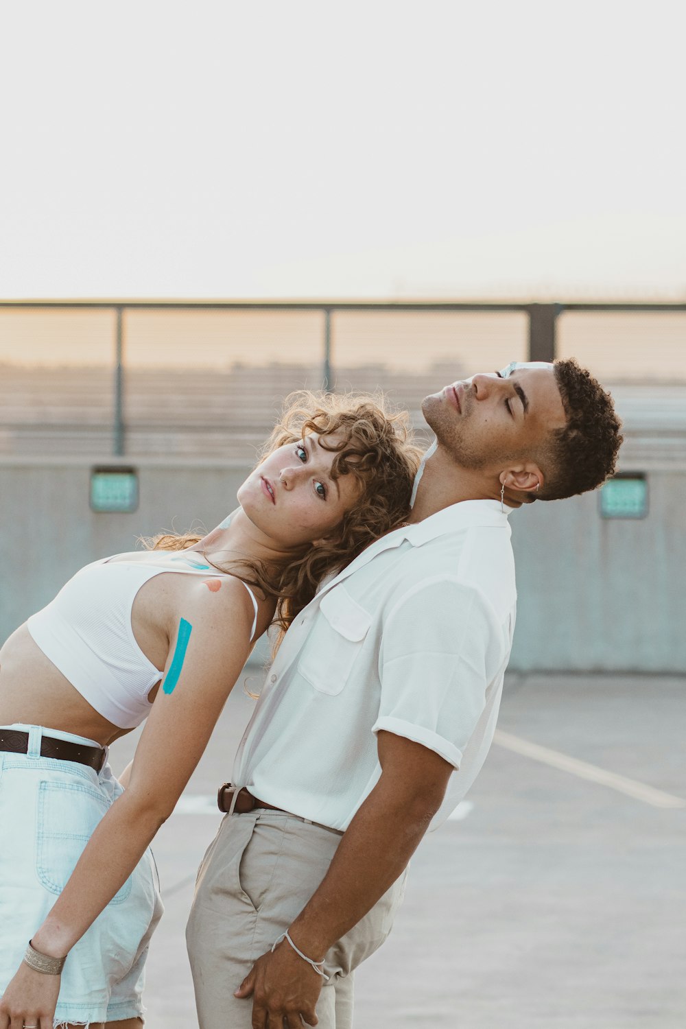 man in white polo shirt kissing woman in white shirt