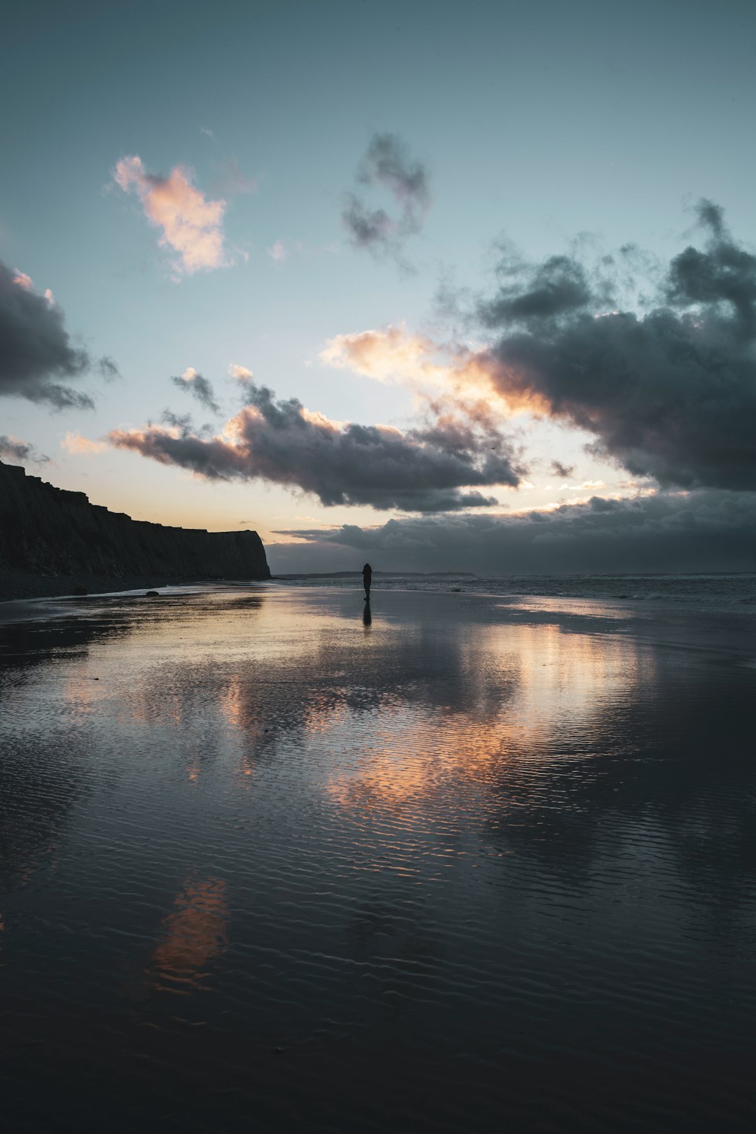 body of water under cloudy sky during daytime