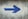 blue arrow sign on gray textile