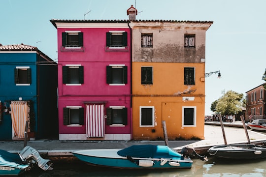 blue boat on dock near building during daytime in Lace Museum Italy