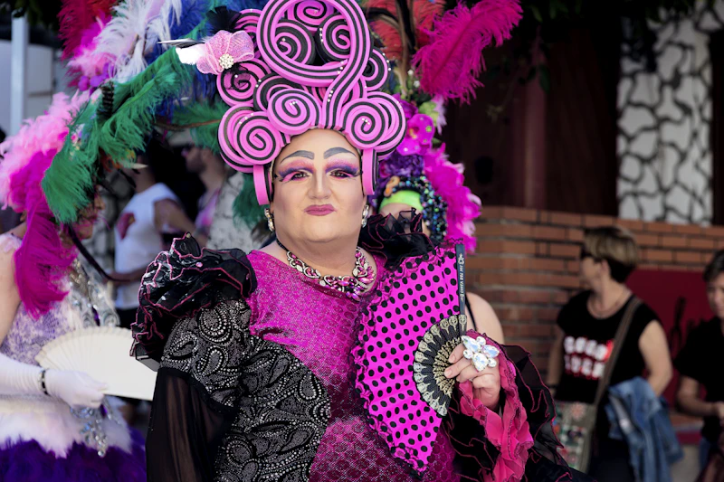 Portrait of a drag performer with an elaborate floral headdress