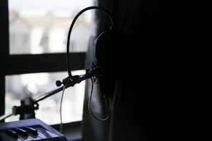 Studio interior showing audio equipment with a window overlooking a city skyline at dusk