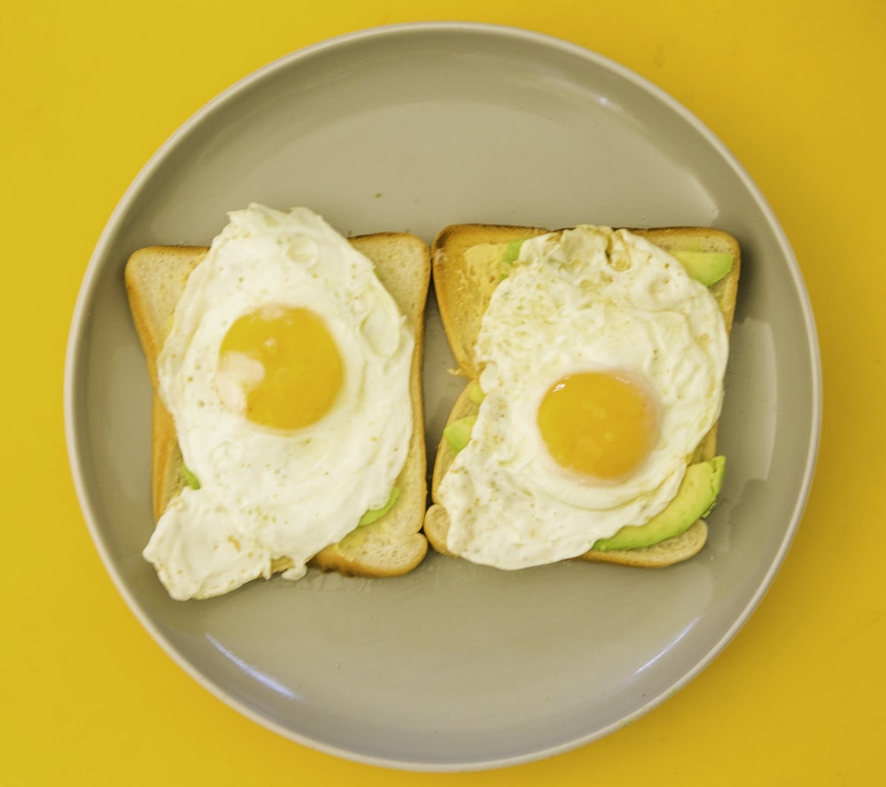 2 sunny side up eggs on green ceramic plate