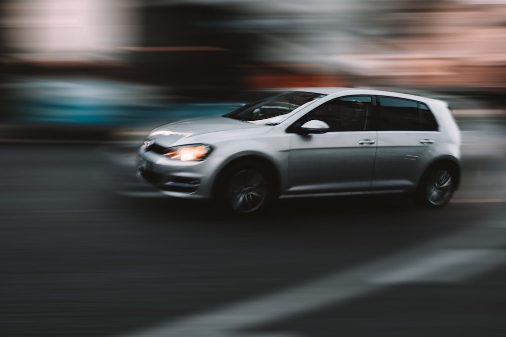 silver sedan on road during daytime