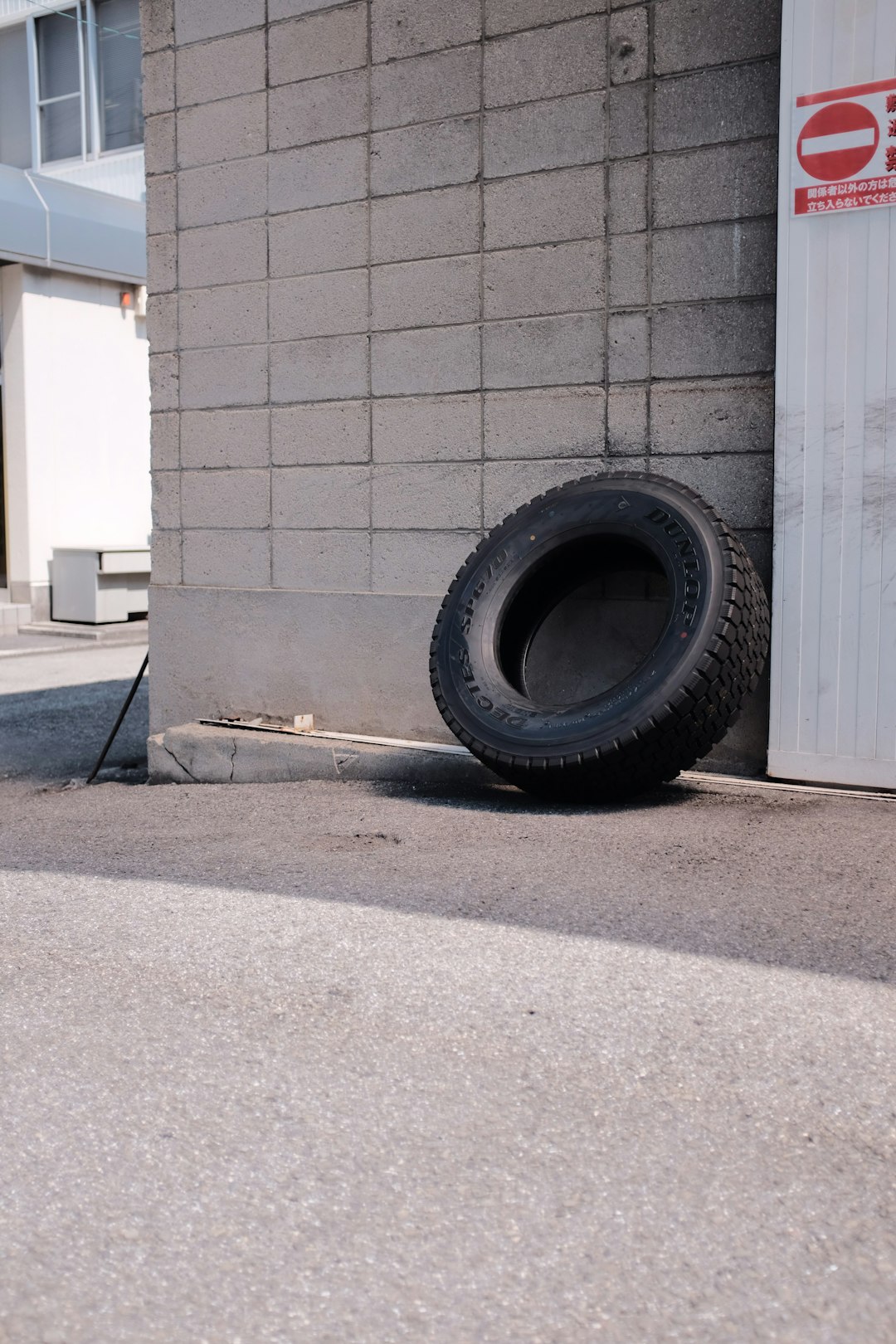 black car tire on gray concrete floor