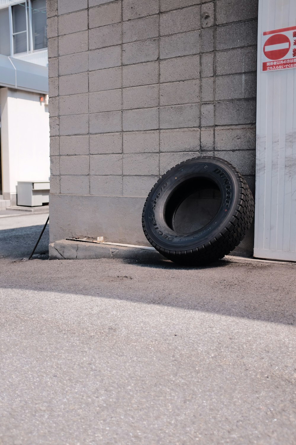 black car tire on gray concrete floor
