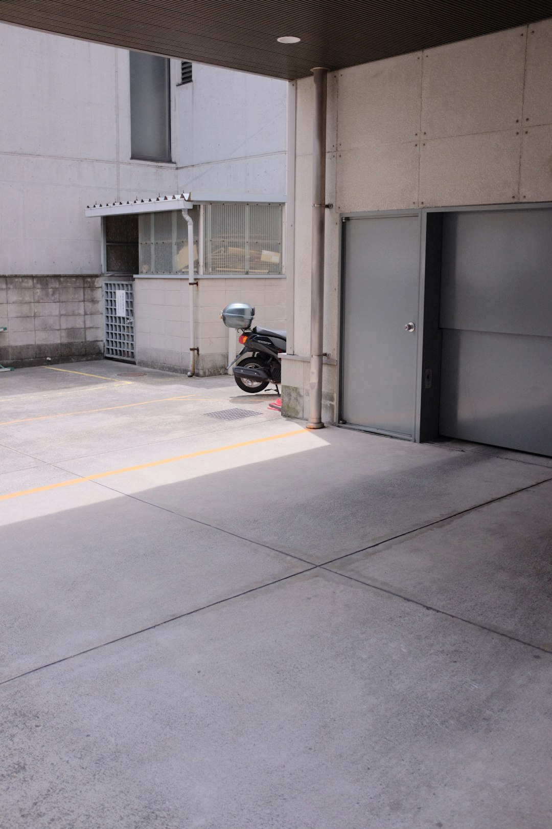 black motorcycle parked near gray metal door