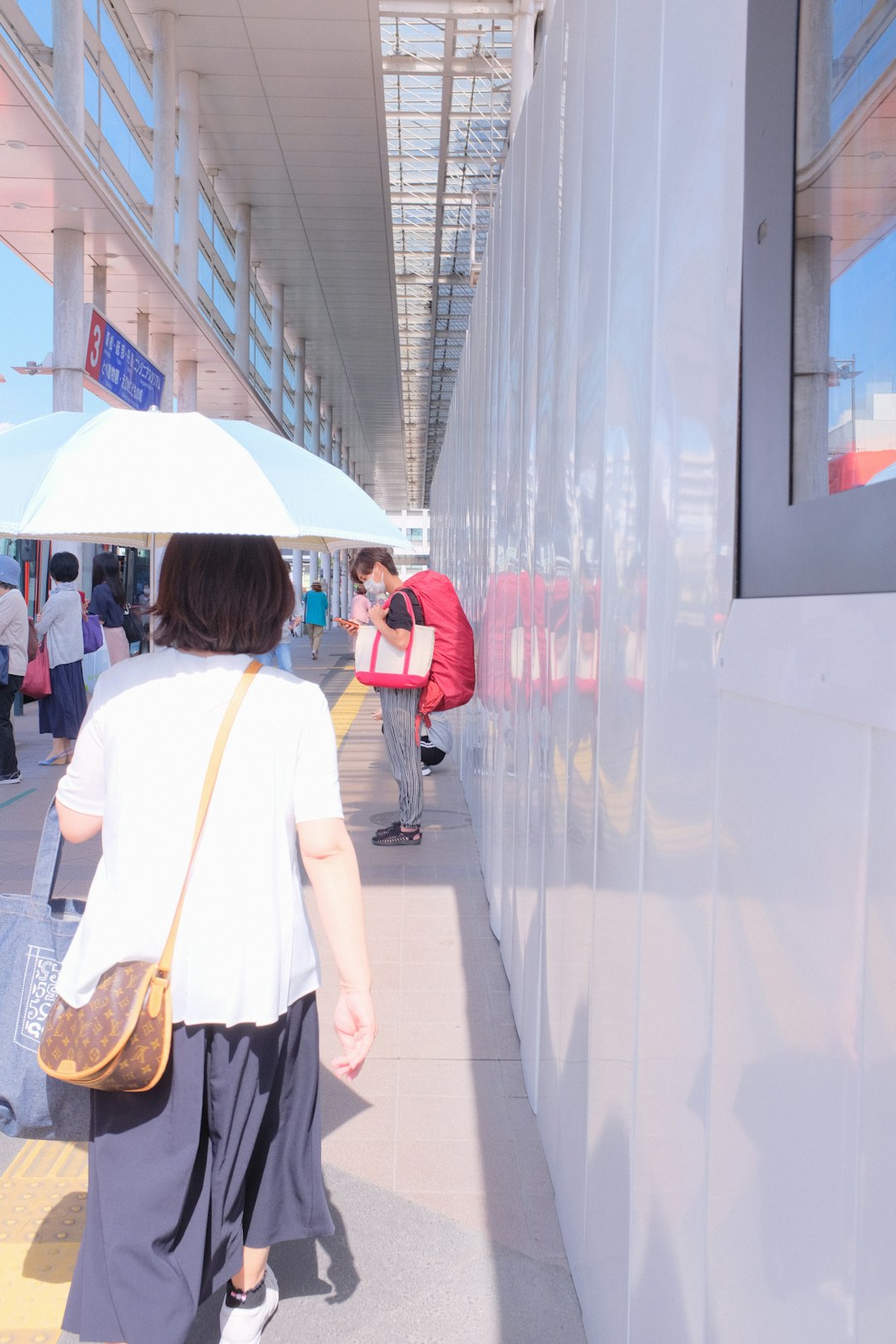 people walking on white tiled floor