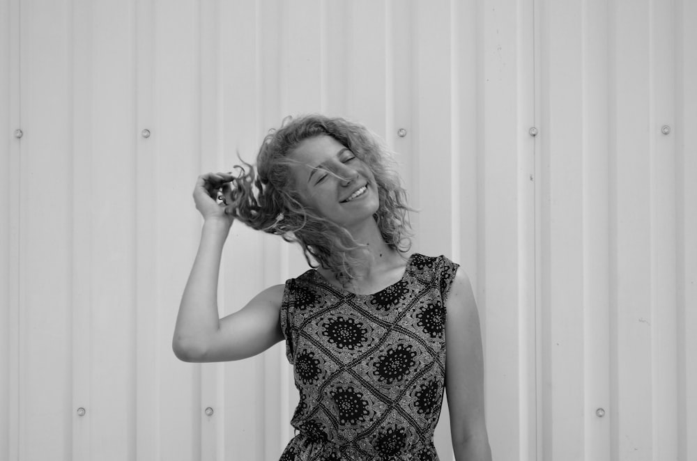 a black and white photo of a woman smiling