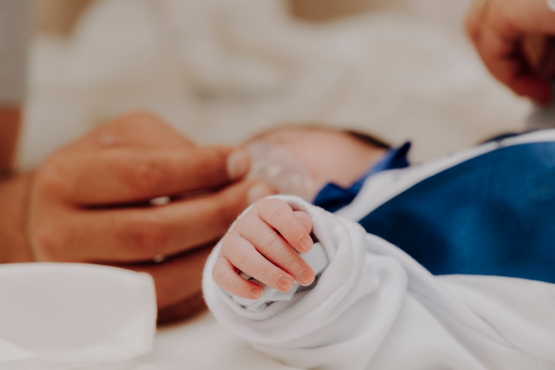 person holding babys hand