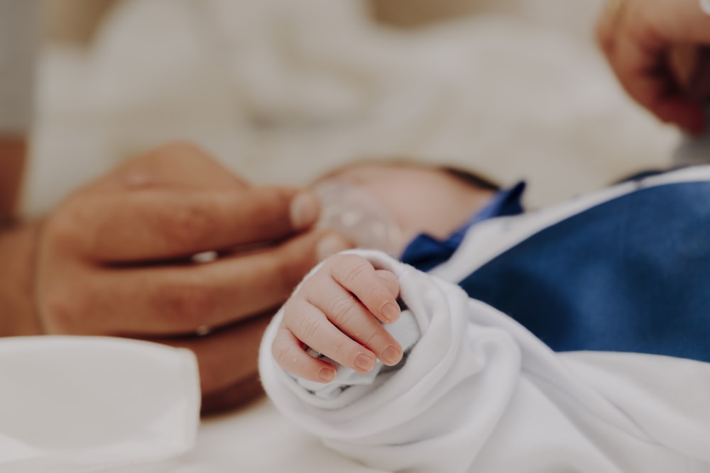 person holding babys hand