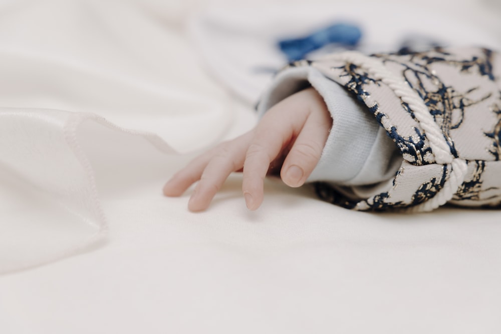 person in white and blue floral long sleeve shirt