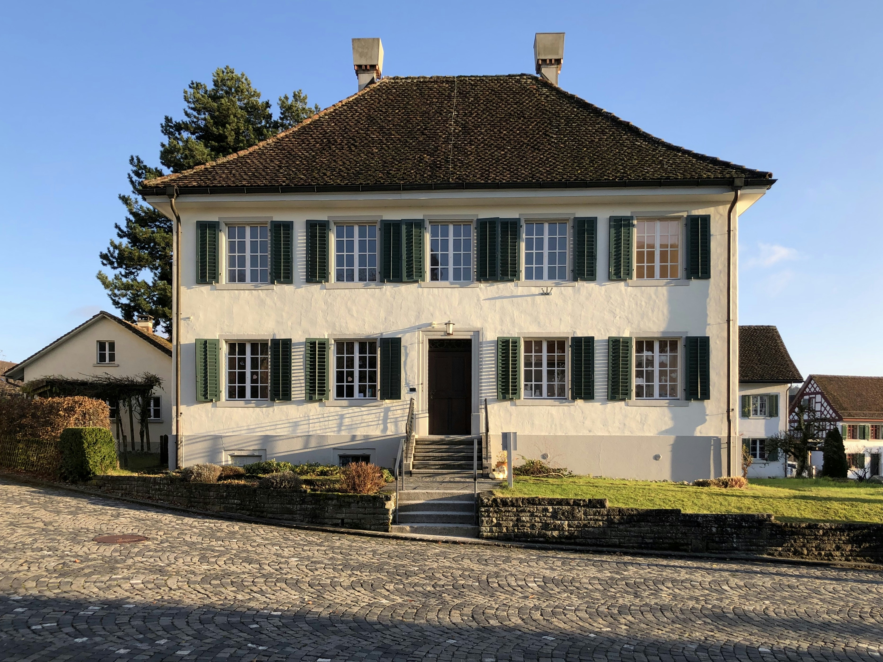 white and brown concrete house under blue sky during daytime