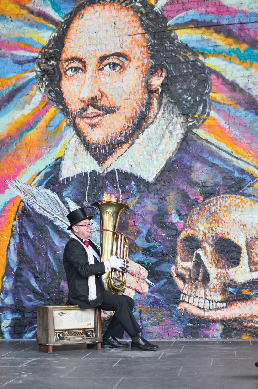 man in black suit jacket holding brass trumpet painting
