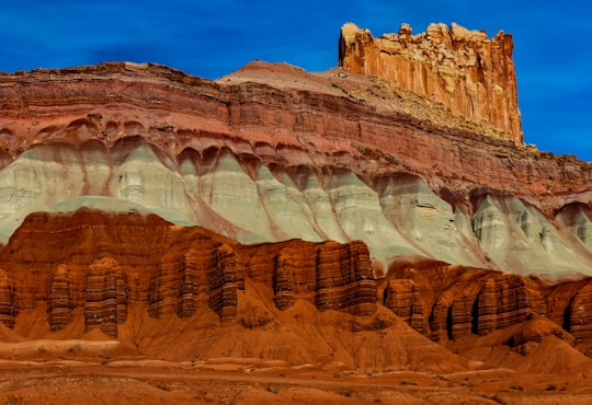 brown rock formation under blue sky during daytime in Capitol Reef National Park United States