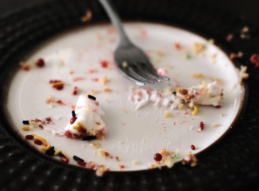 stainless steel fork on white ceramic plate