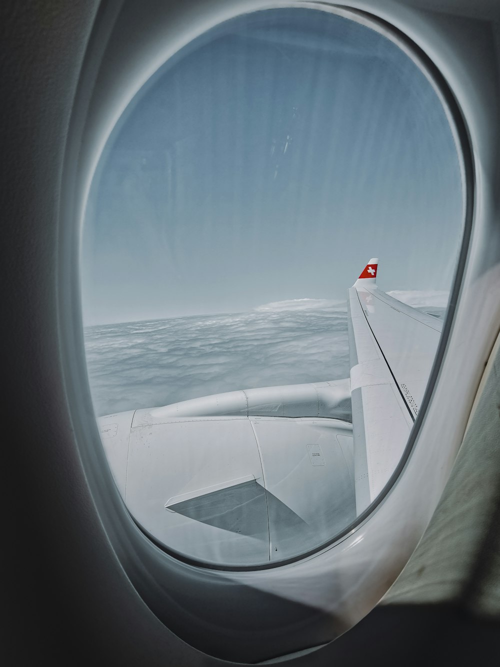 white airplane wing over the sea during daytime