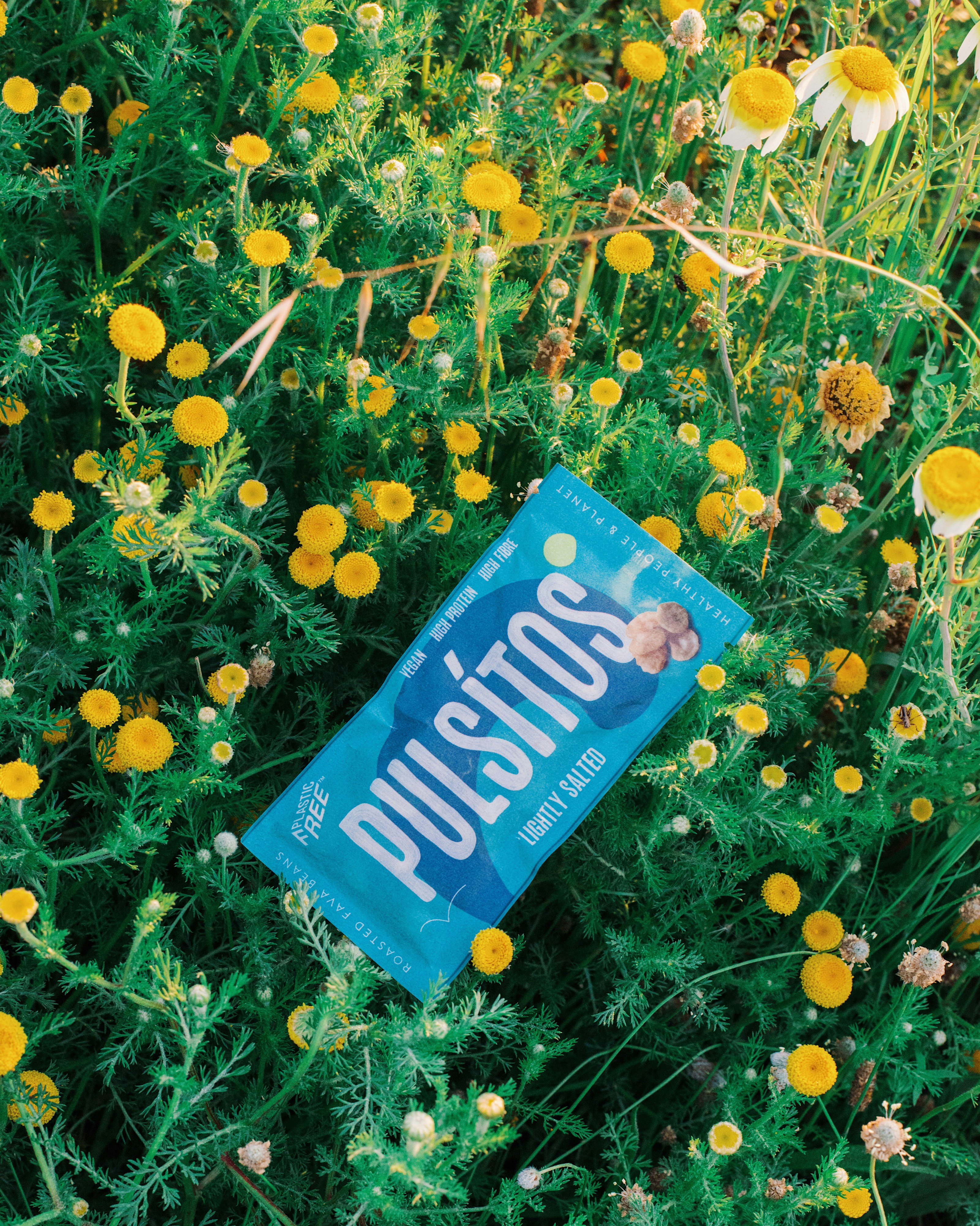 a book laying in the middle of a field of flowers