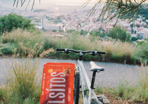 red and black bicycle near green grass field during daytime