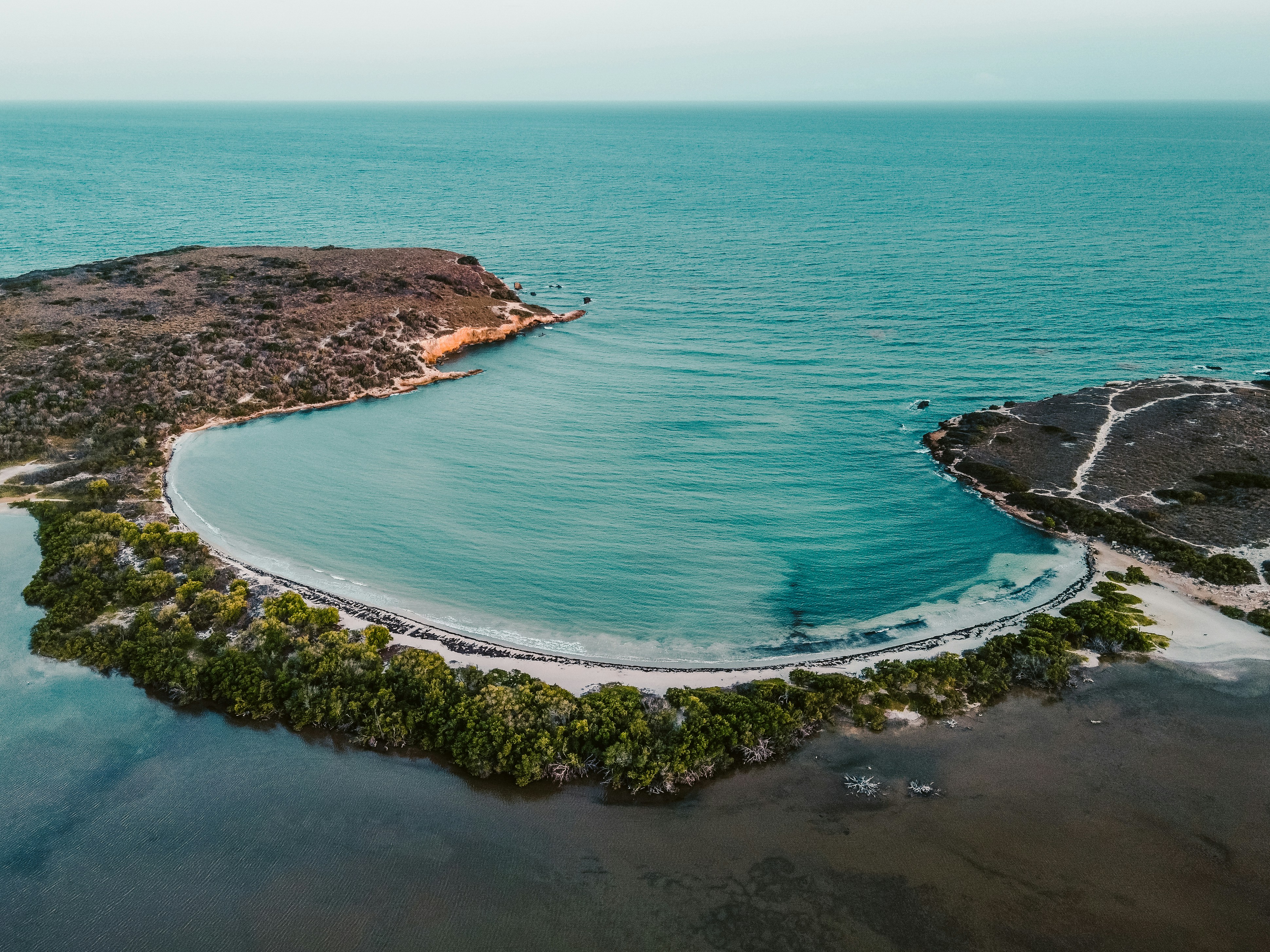 aerial view of green and brown island during daytime, "Dirty beach" That