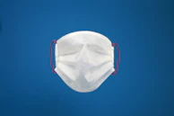 A close-up showing the 3D contoured cut and soft ear loops of an aerisana mask on a mannequin head.