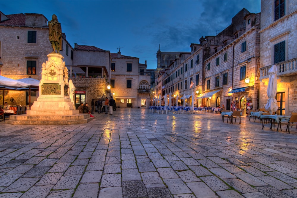 people walking on street near building during night time