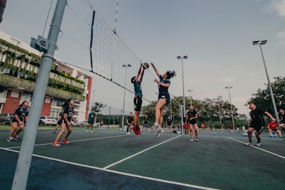 man in black shirt and shorts playing basketball during daytime volleyball google meet background