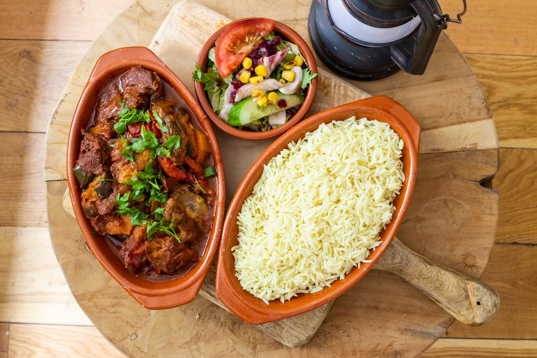 rice and meat dish on brown ceramic bowl