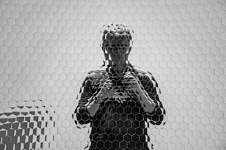 grayscale photo of man in black and white long sleeve shirt