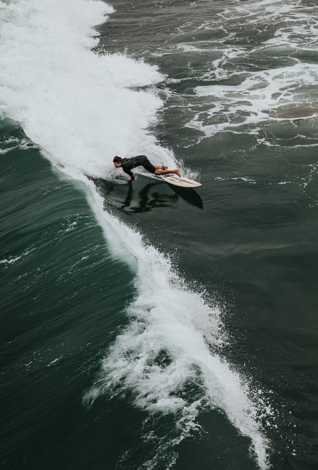 man surfing on green sea during daytime