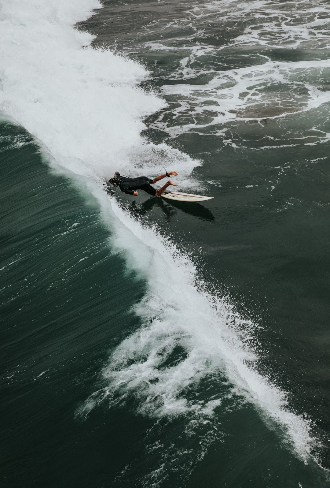 man surfing on sea waves during daytime