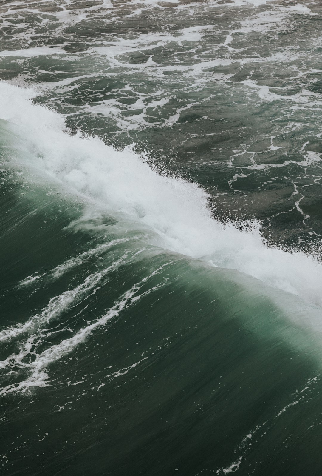 ocean waves crashing on shore during daytime