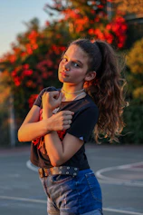 woman in black shirt and blue denim jeans with red lipstick