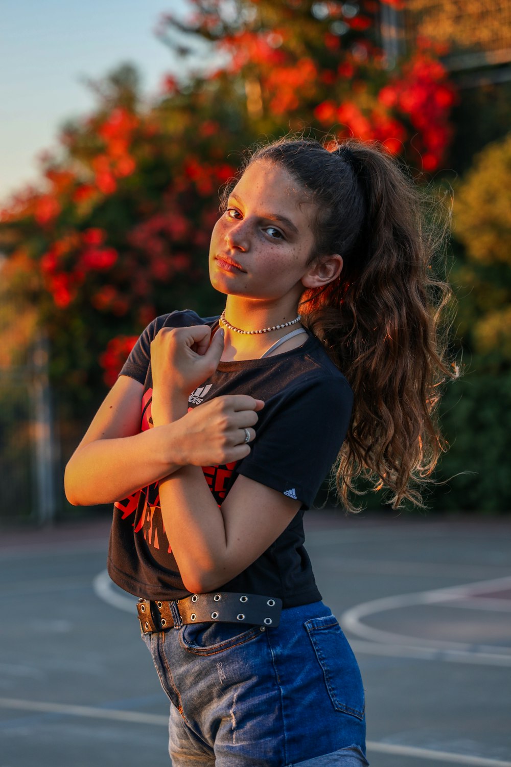 woman in black shirt and blue denim jeans with red lipstick