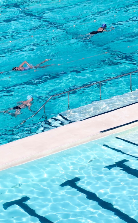 woman in white bikini swimming on pool during daytime