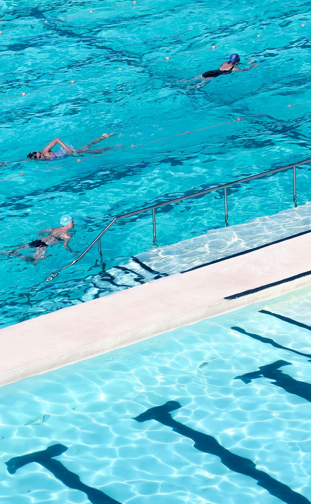 woman in white bikini swimming on pool during daytime