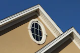 brown concrete building with white window