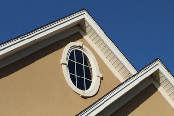 brown concrete building with white window