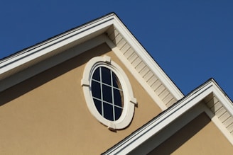 brown concrete building with white window