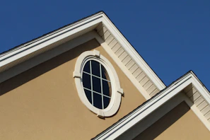brown concrete building with white window