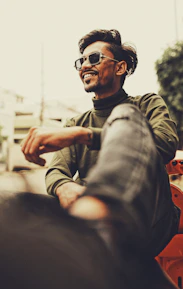 A smiling customer wearing a trendy, comfortable outfit in a city street setting.