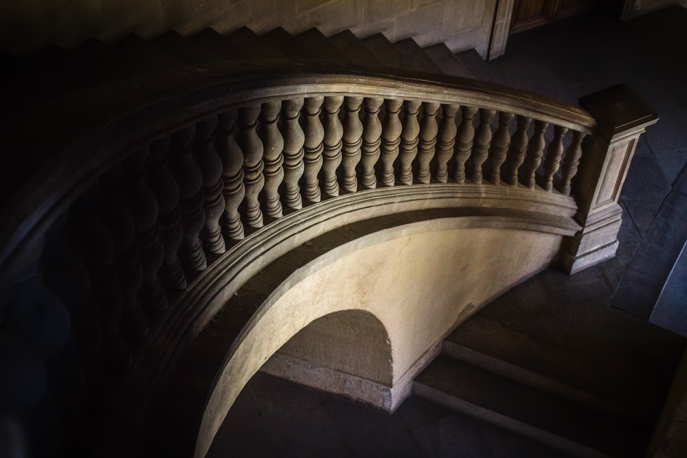 brown wooden spiral staircase in grayscale photography