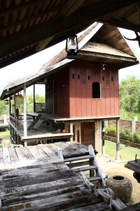 Traditional Javanese joglo house made of teak wood with intricate carvings.